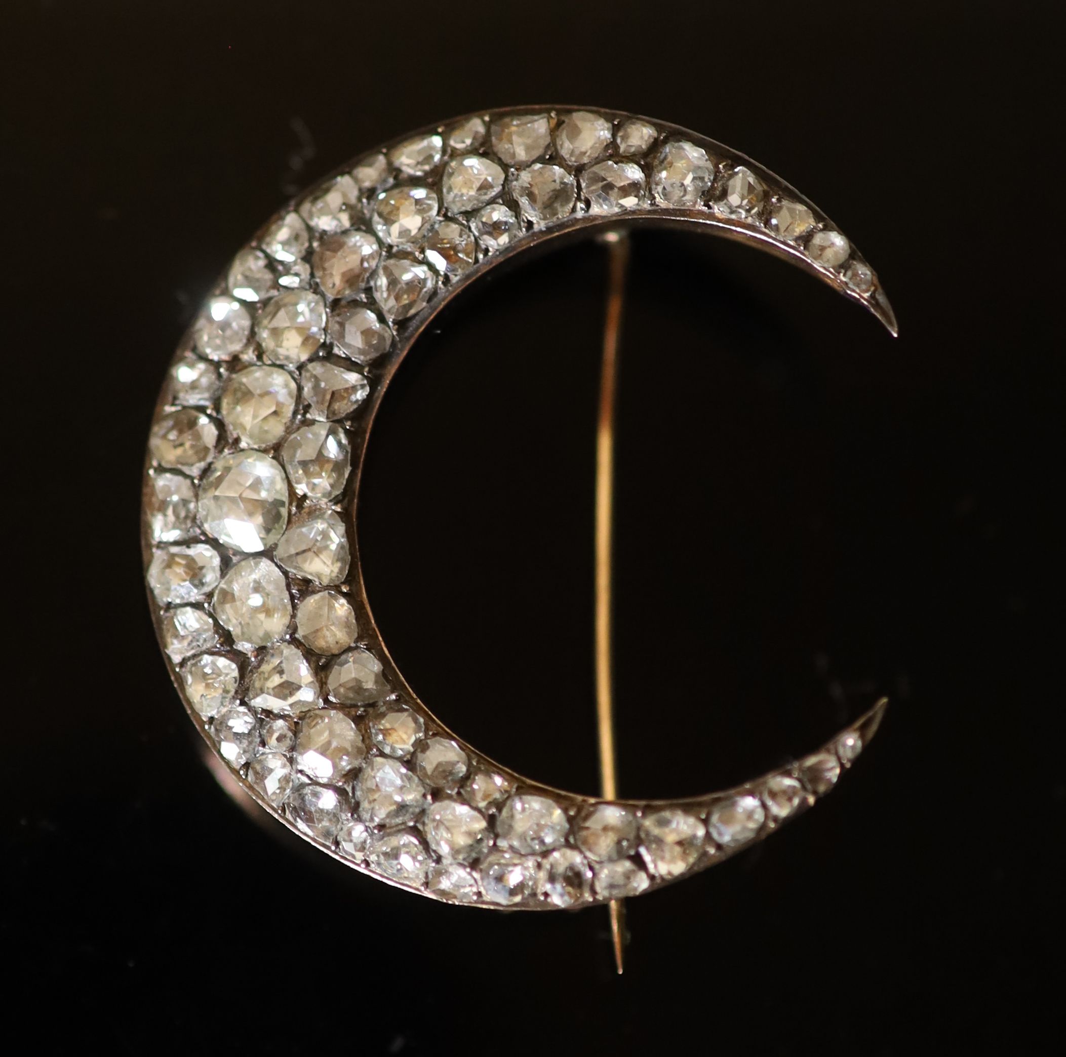 A 19th century French gold and foil backed graduated rose cut diamond set crescent brooch,